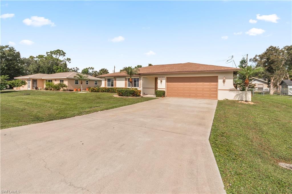 a view of a house with a yard and garage