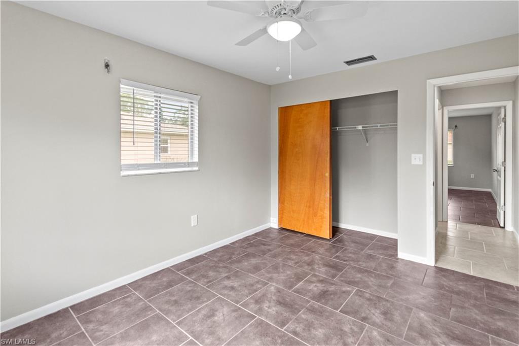 9081 Shaddock Road West Fort Myers, FL 33967 - Photo 15 of 23 an empty room with closet and a chandelier fan