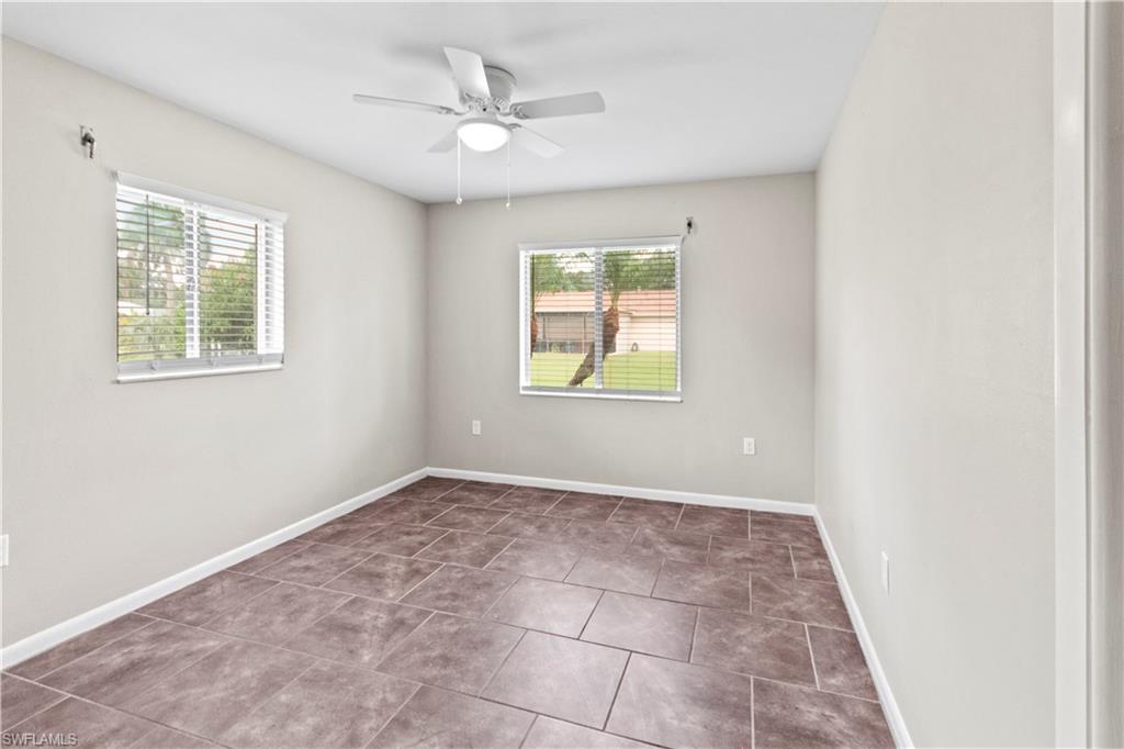 9081 Shaddock Road West Fort Myers, FL 33967 - Photo 16 of 23 an empty room with windows and fan