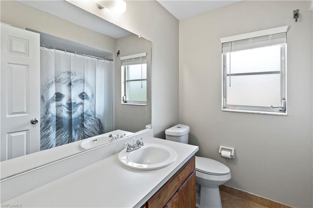 9081 Shaddock Road West Fort Myers, FL 33967 - Photo 18 of 23 a bathroom with a sink toilet and shower