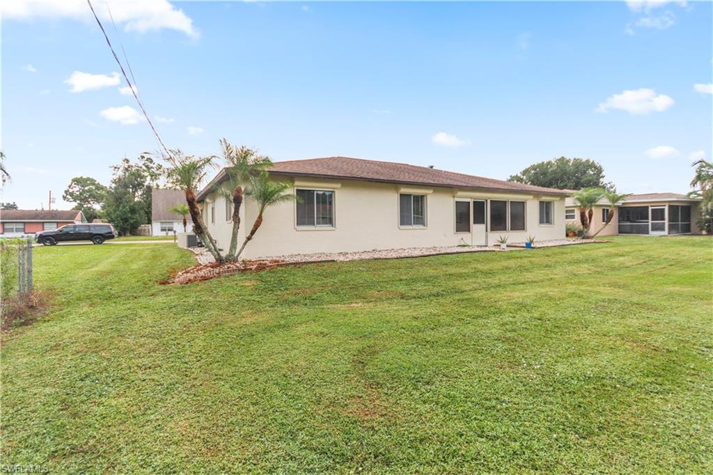 9081 Shaddock Road West Fort Myers, FL 33967 - Photo 22 of 23 a view of a house with a yard and sitting area