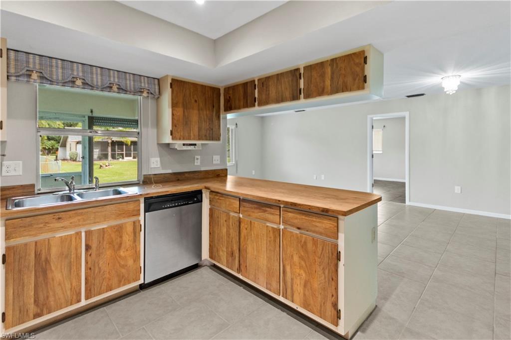 9081 Shaddock Road West Fort Myers, FL 33967 - Photo 7 of 23 a kitchen with stainless steel appliances granite countertop a refrigerator and a sink