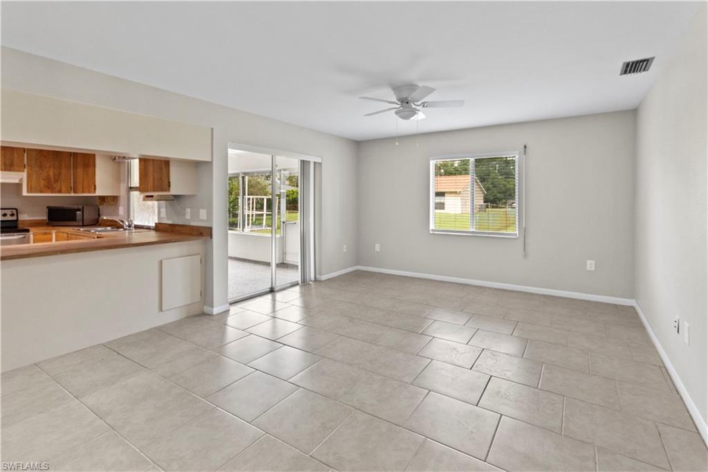 9081 Shaddock Road West Fort Myers, FL 33967 - Photo 9 of 23 a large white kitchen with a sink a window and stainless steel appliances