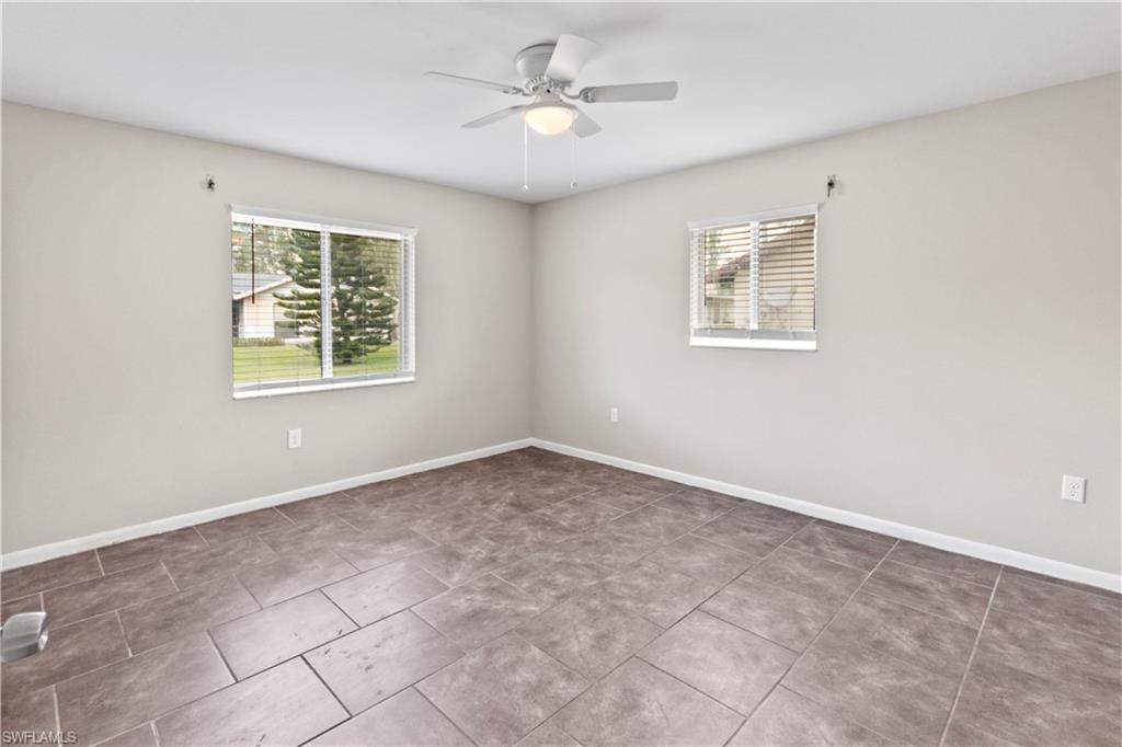 9081 Shaddock Road West Fort Myers, FL 33967 - Photo 10 of 23 an empty room with windows and ceiling fan