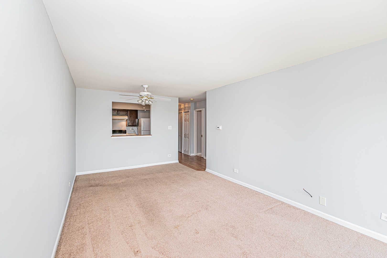701 West Huntington Commons Road, Unit 211 Mount Prospect, IL 60056 - Photo 4 of 26 an empty room with windows