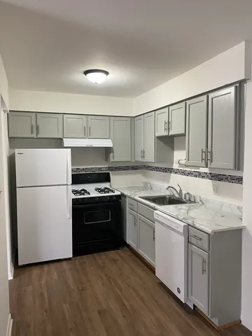a kitchen with a sink stove and refrigerator