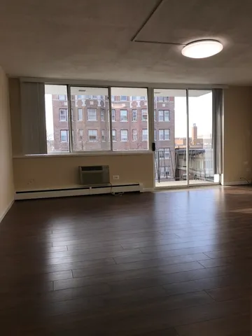 a view of room with window and wooden floor