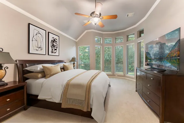 a bedroom with a bed and a large window