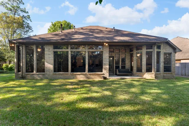 a view of a white building with a large garden and plants