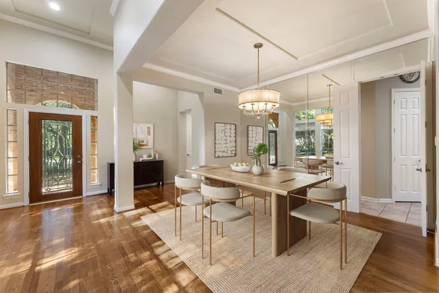 a view of a dining room with furniture wooden floor and chandelier