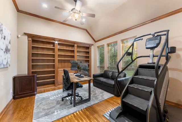 a living room with furniture a ceiling fan and a rug