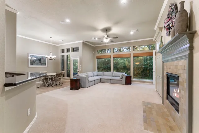 a kitchen with stainless steel appliances granite countertop a barbecue grill and couches with wooden floor