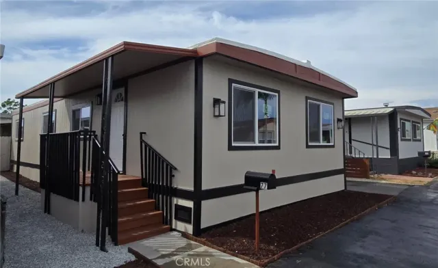 a view of a house with wooden walls and stairs