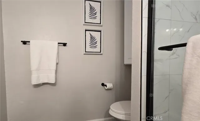 a white toilet sitting next to a bathroom sink