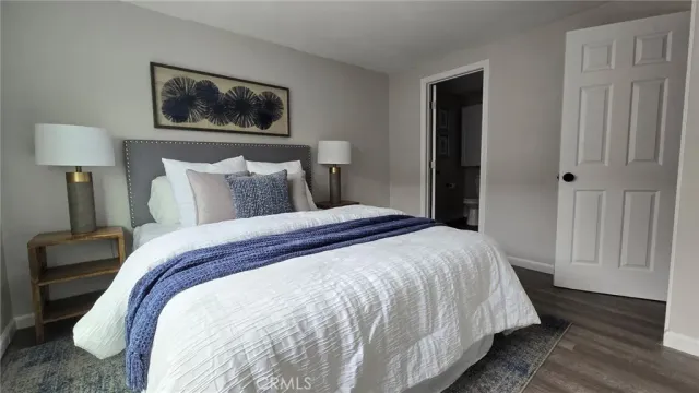 a bedroom with bed and wall painting