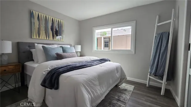 a bedroom with a bed and a window