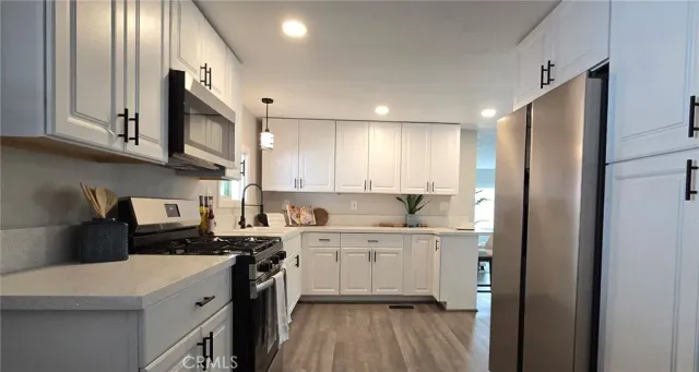 a kitchen with a sink a stove top oven and cabinets