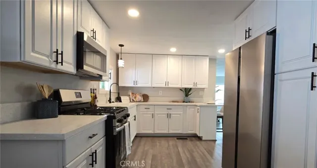a kitchen with a sink a stove top oven and cabinets