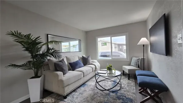 a living room with furniture and a potted plant