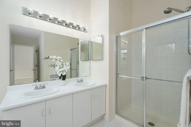 a bathroom with a shower sink and mirror