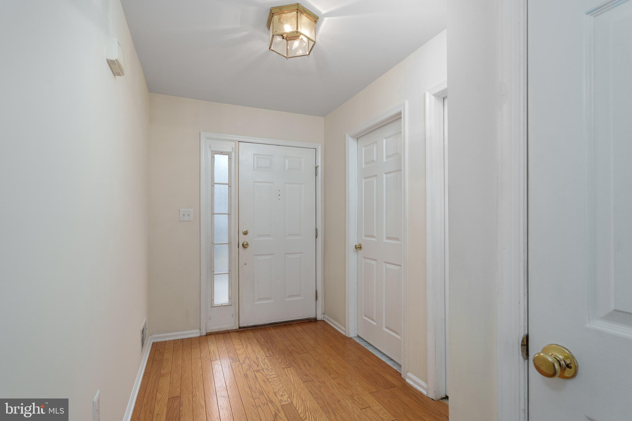 610 Bollen Court Pennington, NJ 08534 - Photo 2 of 30 a view of an empty room with window and wooden floor