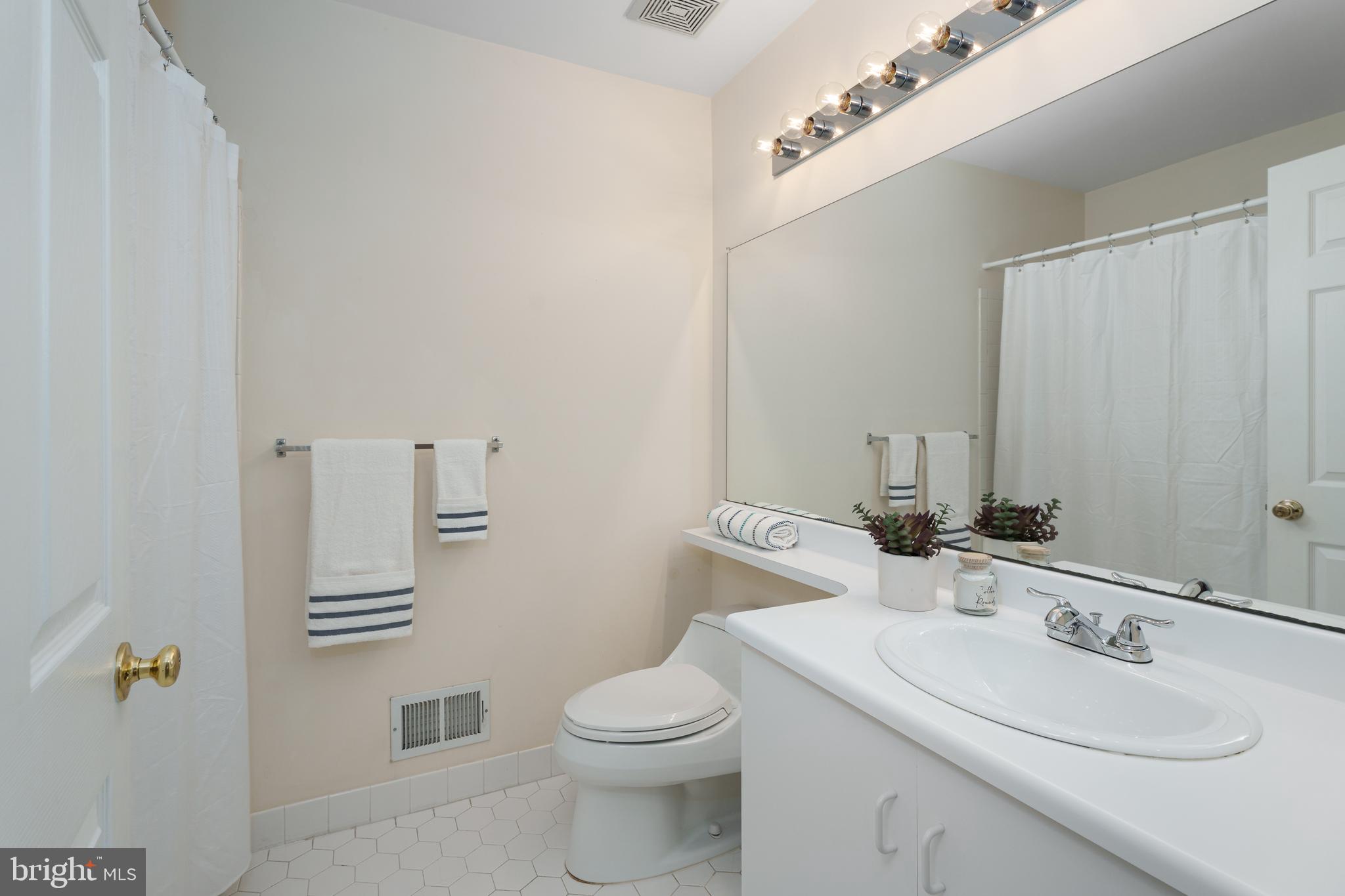 610 Bollen Court Pennington, NJ 08534 - Photo 22 of 30 a bathroom with a sink a toilet and mirror