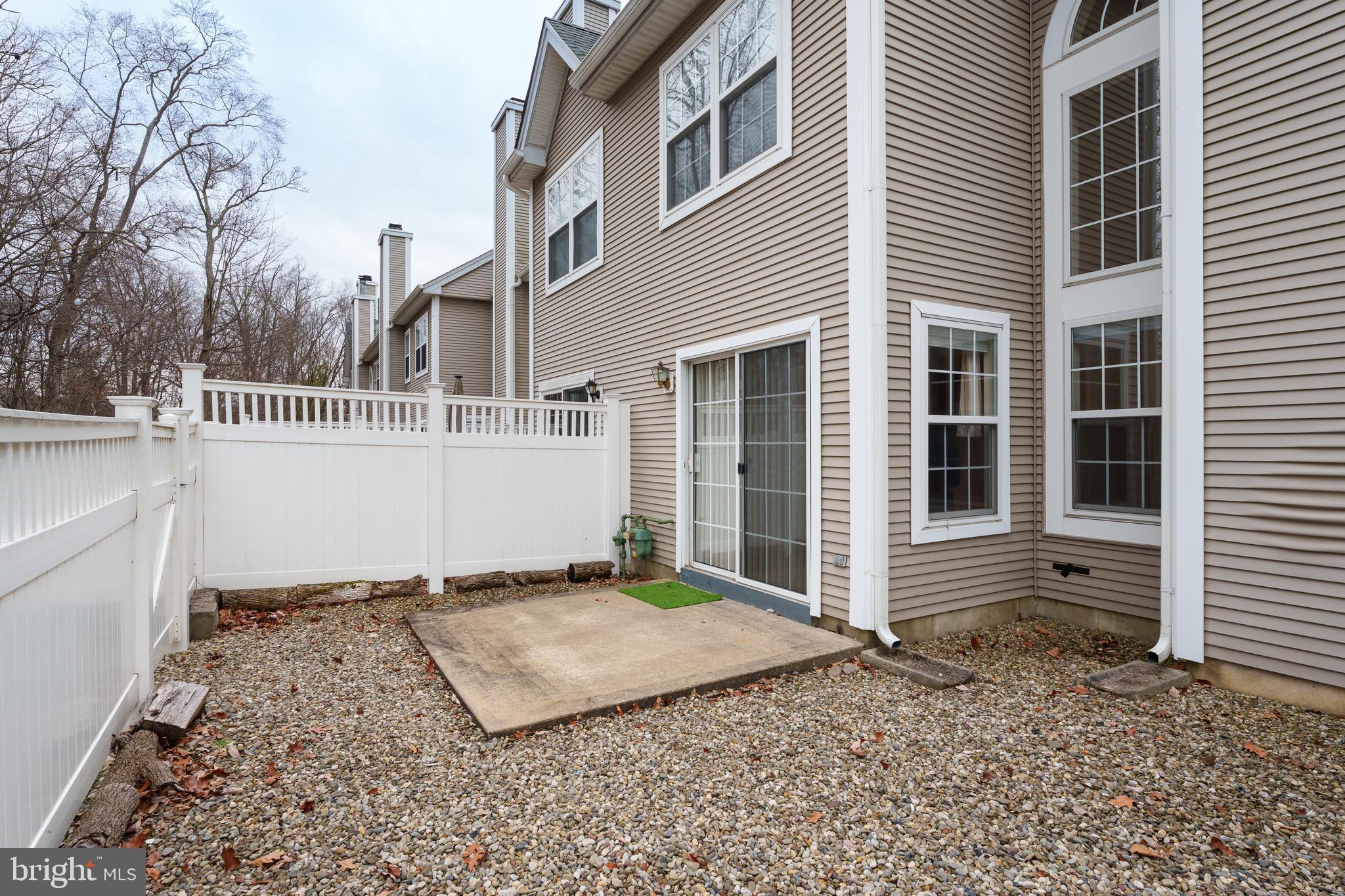 610 Bollen Court Pennington, NJ 08534 - Photo 25 of 30 a view of a house with a small yard and wooden fence