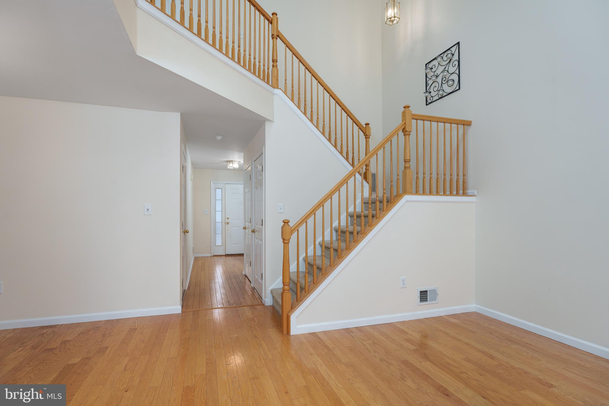 610 Bollen Court Pennington, NJ 08534 - Photo 3 of 30 a view of staircase with wooden floor and white walls
