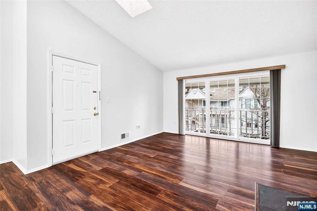 556 Holly Court Mahwah, NJ 07430 - Photo 11 of 46 a view of an empty room with wooden floor and a window