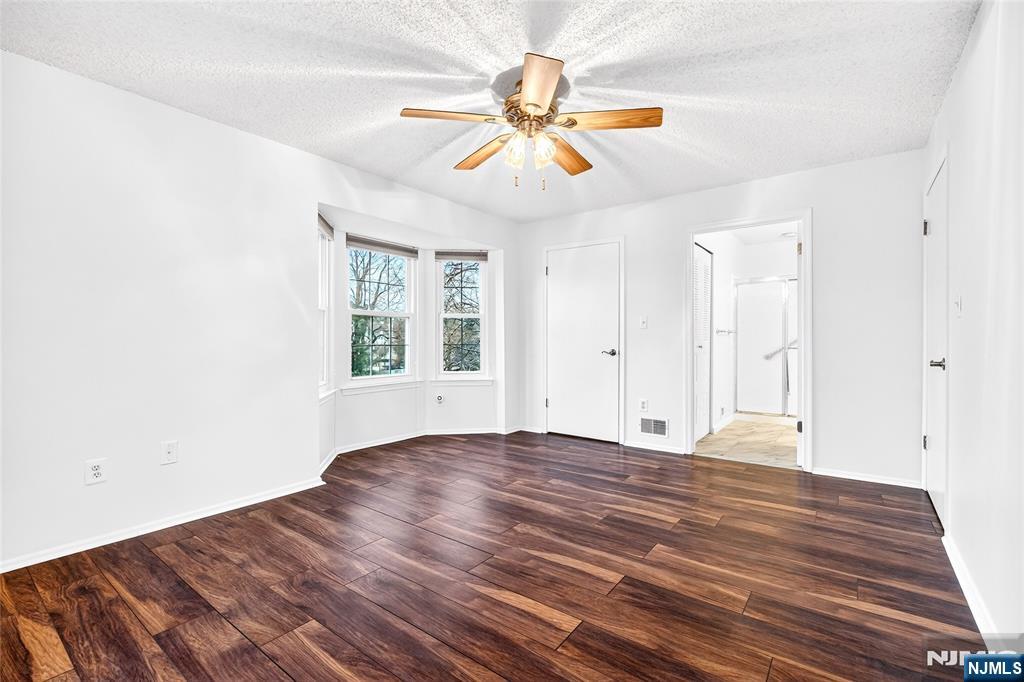 556 Holly Court Mahwah, NJ 07430 - Photo 21 of 46 a view of empty room with wooden floor and fan