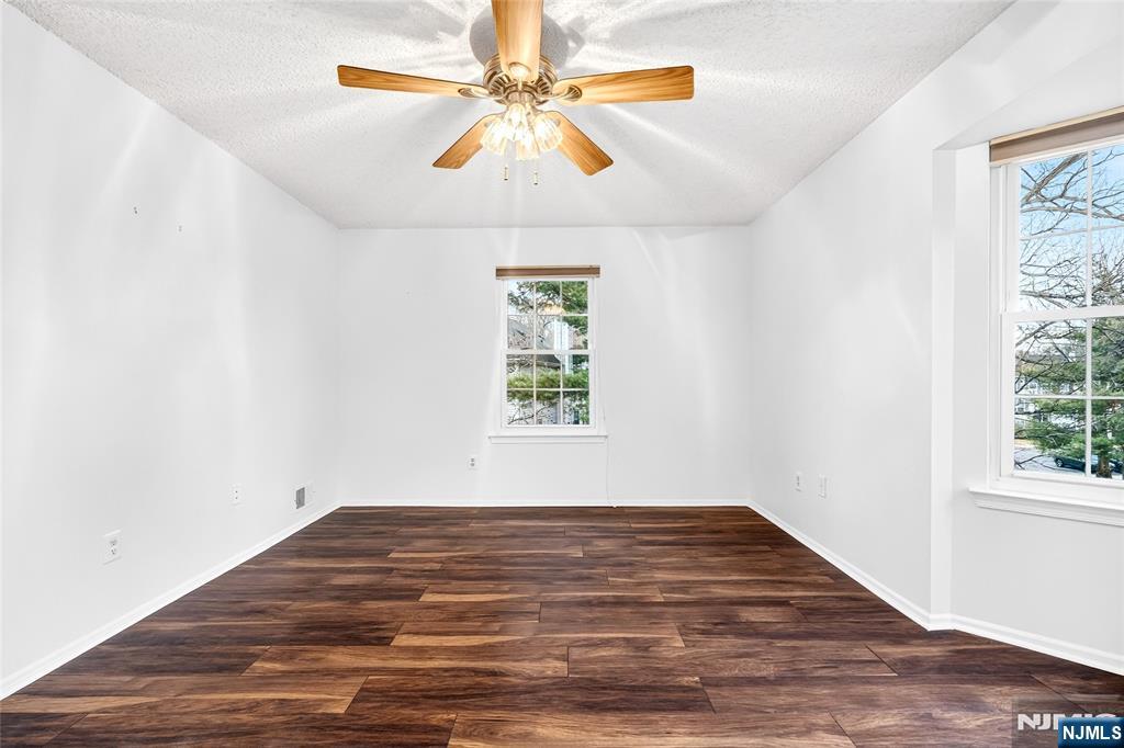 556 Holly Court Mahwah, NJ 07430 - Photo 26 of 46 an empty room with a window and a ceiling fan