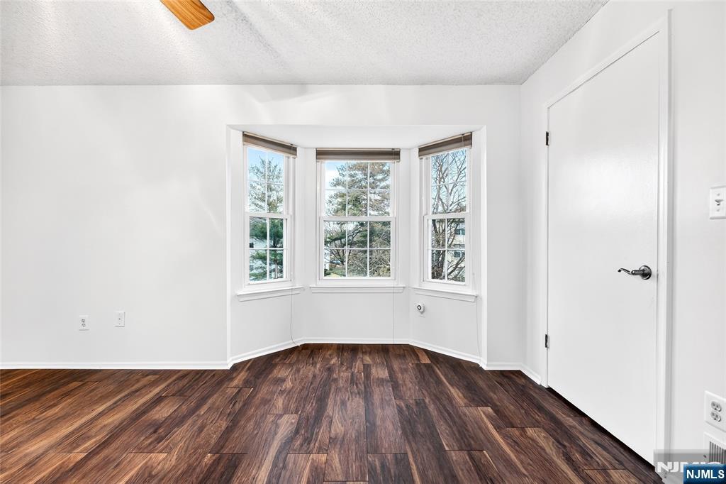 556 Holly Court Mahwah, NJ 07430 - Photo 27 of 46 a view of an empty room with wooden floor and a window