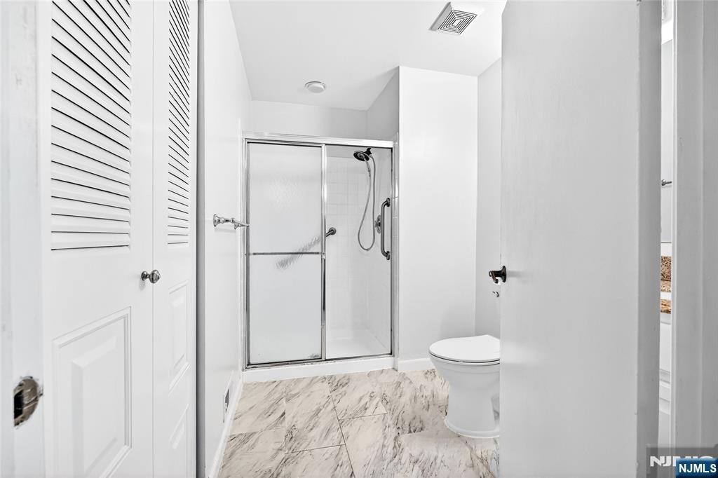 556 Holly Court Mahwah, NJ 07430 - Photo 28 of 46 a bathroom with a shower and a toilet