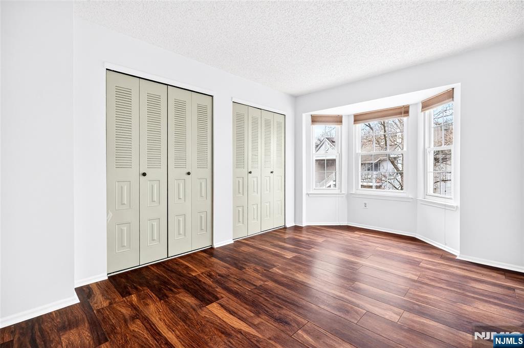 556 Holly Court Mahwah, NJ 07430 - Photo 32 of 46 a view of an empty room with wooden floor and a window