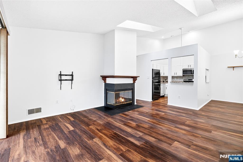 556 Holly Court Mahwah, NJ 07430 - Photo 5 of 46 a view of a kitchen with wooden floor and a refrigerator