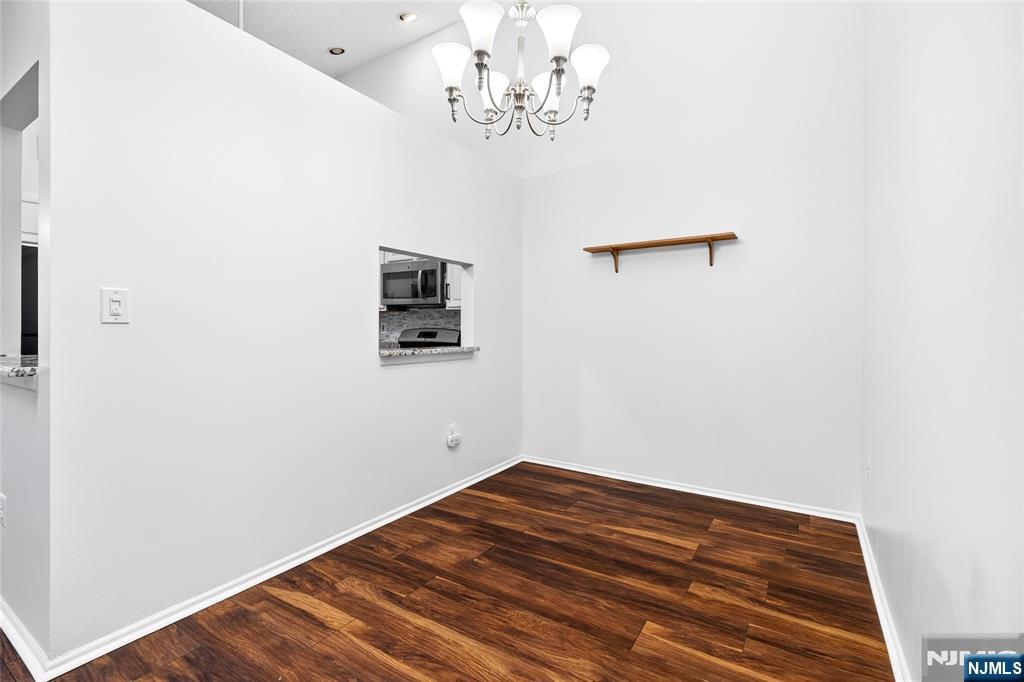 556 Holly Court Mahwah, NJ 07430 - Photo 7 of 46 a view of a room with wooden floor and chandelier