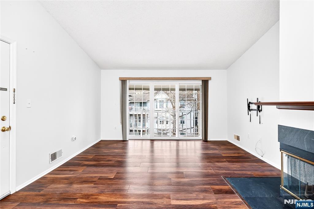 556 Holly Court Mahwah, NJ 07430 - Photo 9 of 46 a view of an empty room with wooden floor and a window
