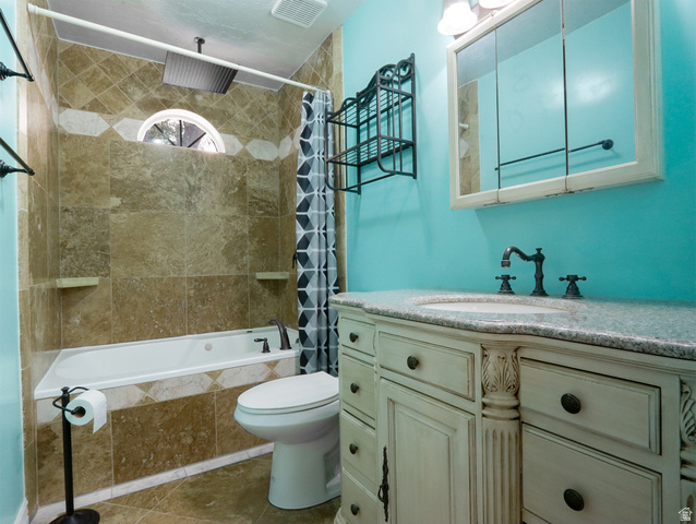 270 East 100 North Monroe, UT 84754 - Photo 28 of 65 Bathroom featuring a corner soaking tub with tile surround, a built-in medicine cabinet, and a vanity with an integrated sink and stone countertop