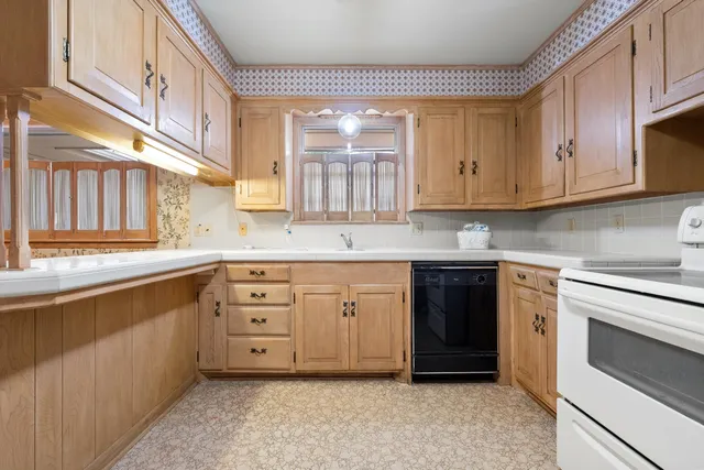 a kitchen with granite countertop a sink stainless steel appliances and cabinets