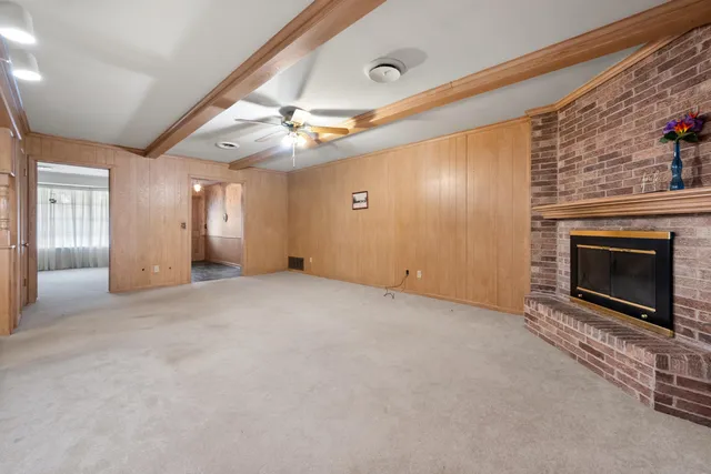 a view of an empty room with a fireplace