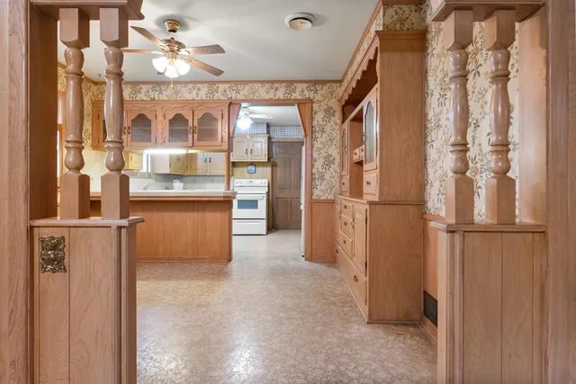 a view of kitchen with refrigerator and cabinets