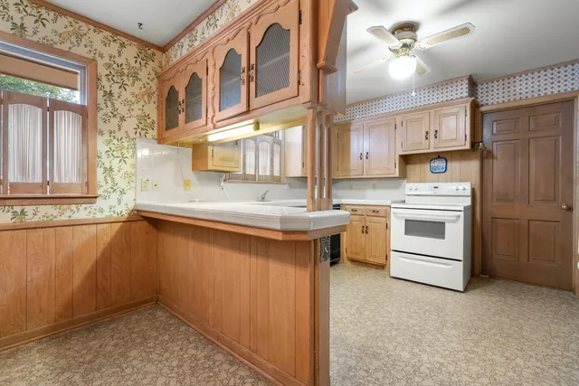 a kitchen with stainless steel appliances white cabinets and a sink
