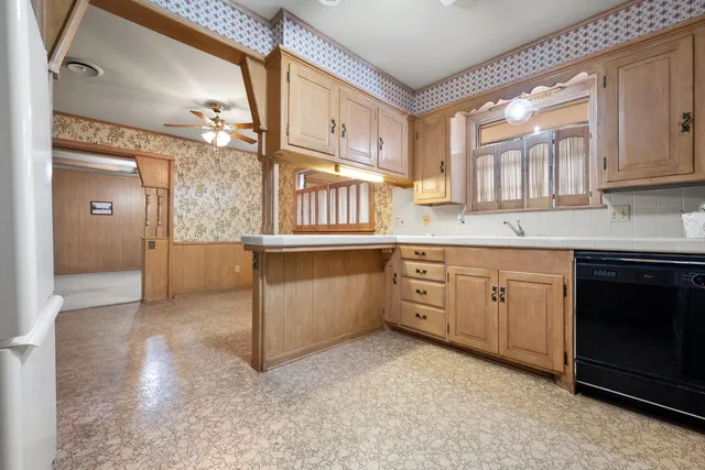 a kitchen with cabinets and window