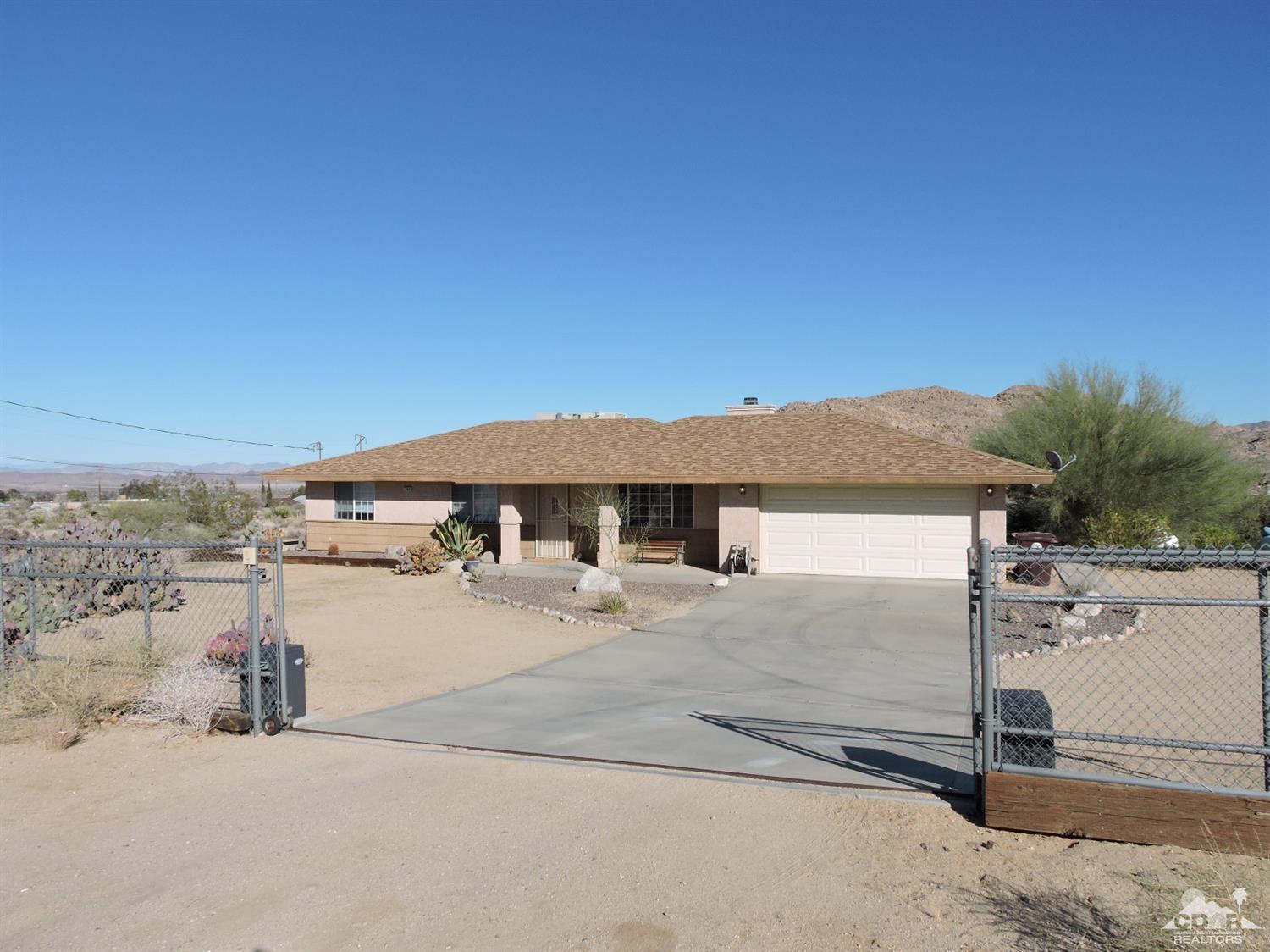7369 Sunset Road Joshua Tree, CA 92252 - Photo 1 of 37 a view of a house with a yard