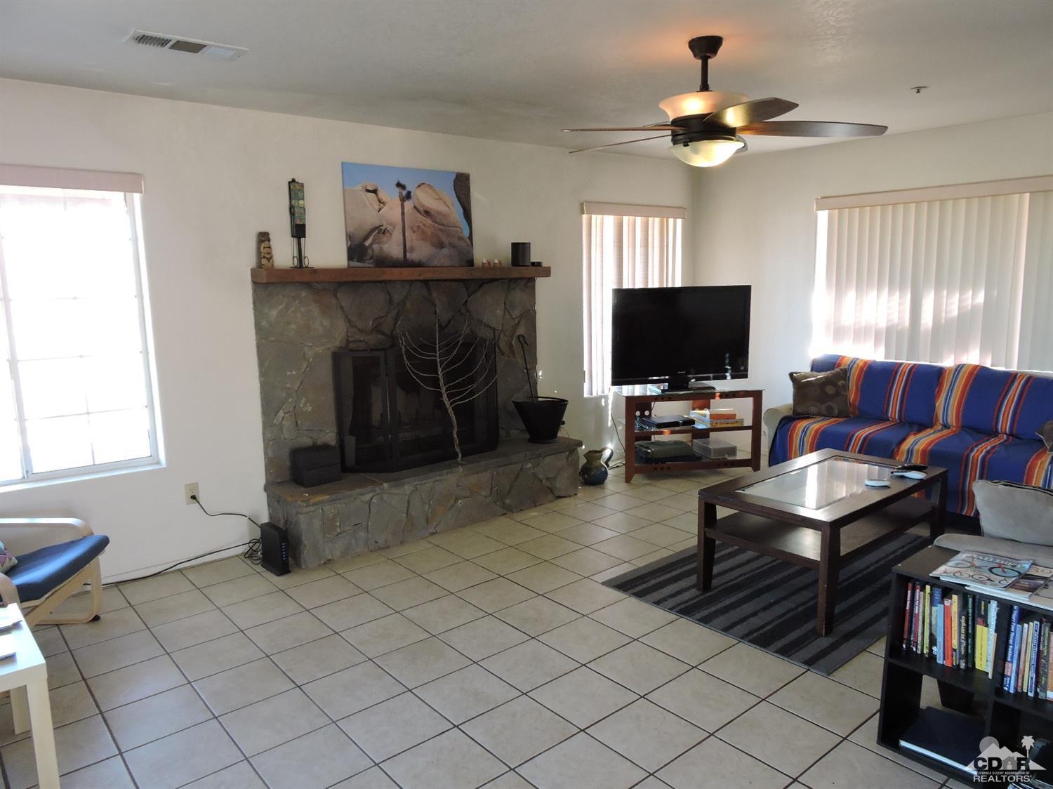 7369 Sunset Road Joshua Tree, CA 92252 - Photo 12 of 37 a living room with furniture and a fireplace