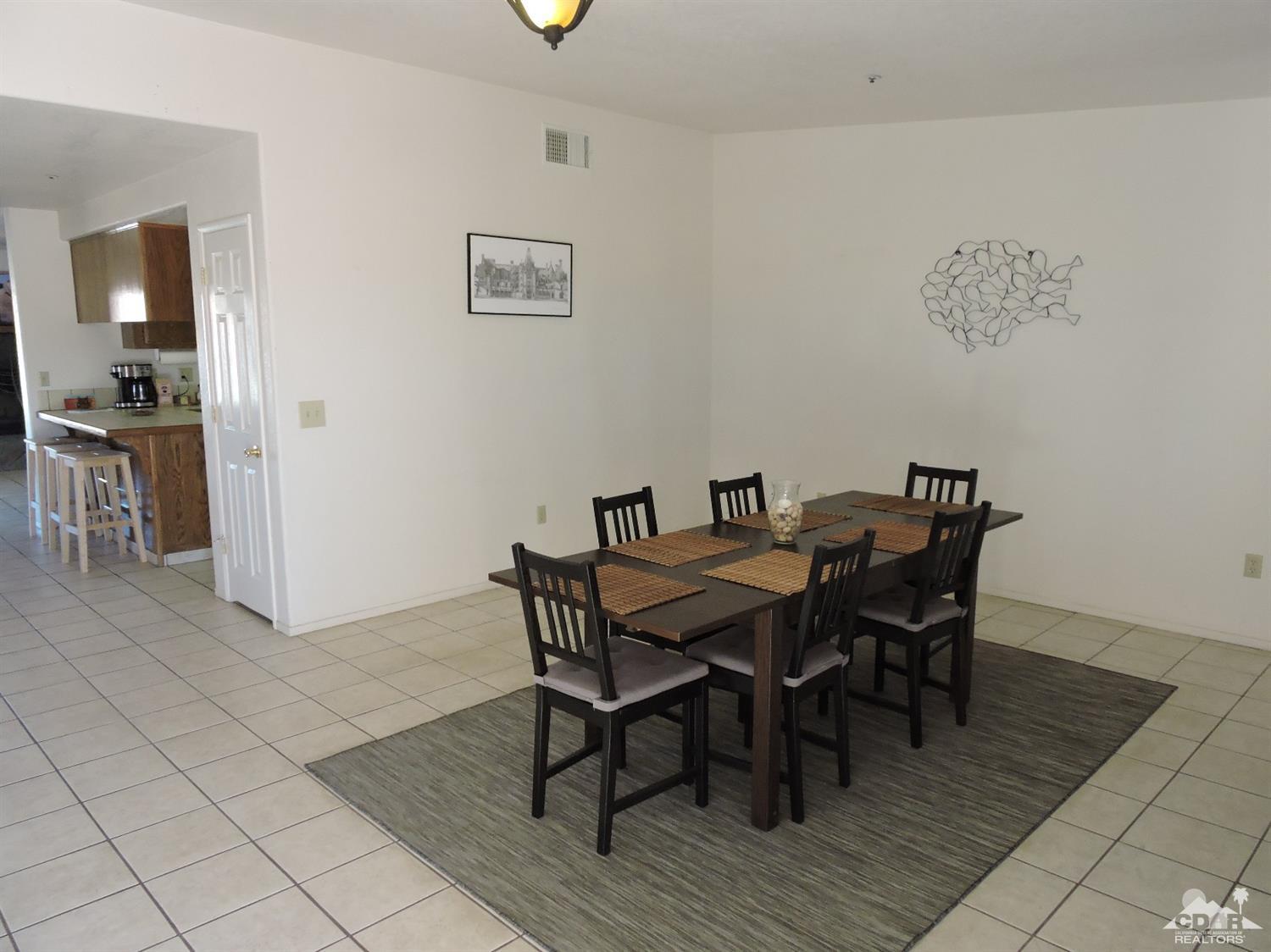7369 Sunset Road Joshua Tree, CA 92252 - Photo 13 of 37 a view of a dining room with furniture and wooden floor