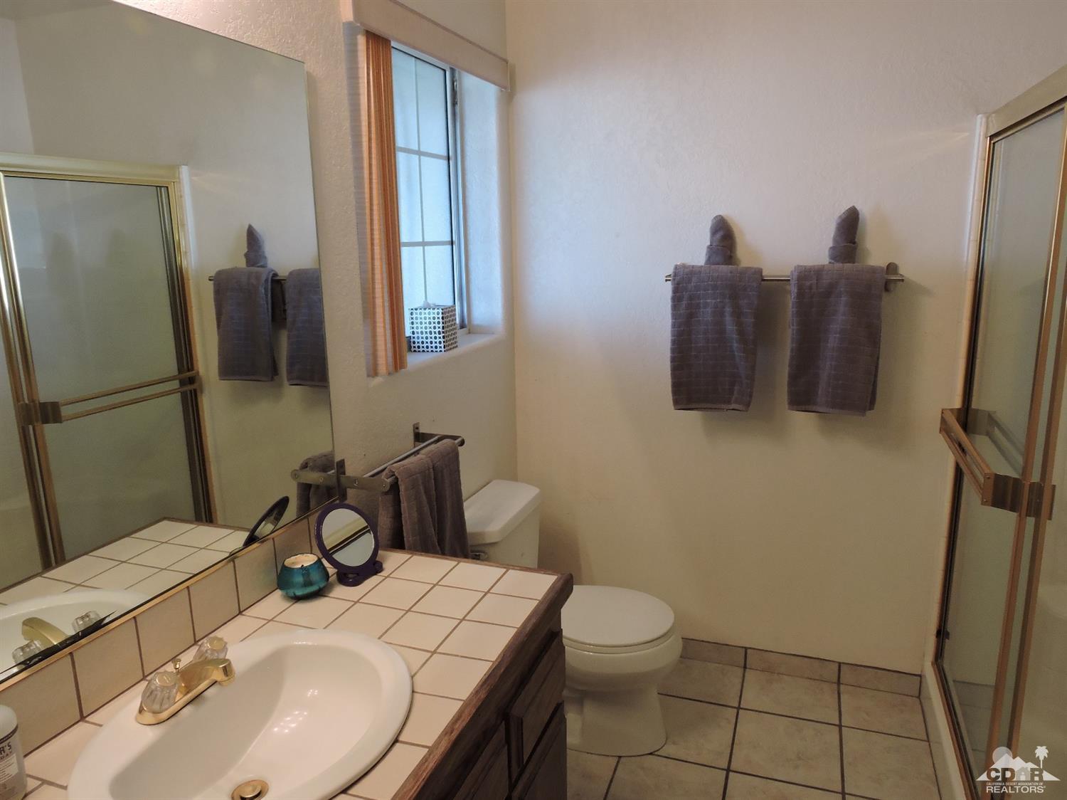 7369 Sunset Road Joshua Tree, CA 92252 - Photo 17 of 37 a bathroom with a sink toilet and mirror
