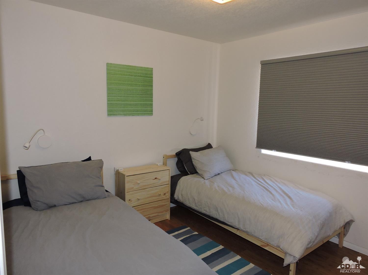 7369 Sunset Road Joshua Tree, CA 92252 - Photo 19 of 37 a bedroom with a bed and a couch