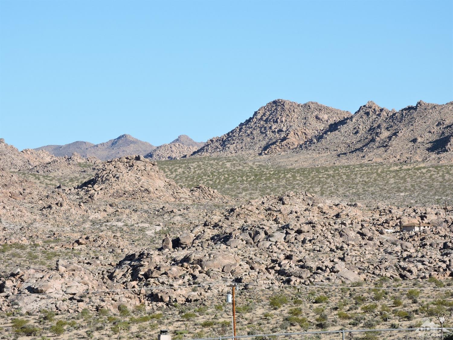 7369 Sunset Road Joshua Tree, CA 92252 - Photo 3 of 37 a view of a large mountain with the view of mountains in the background