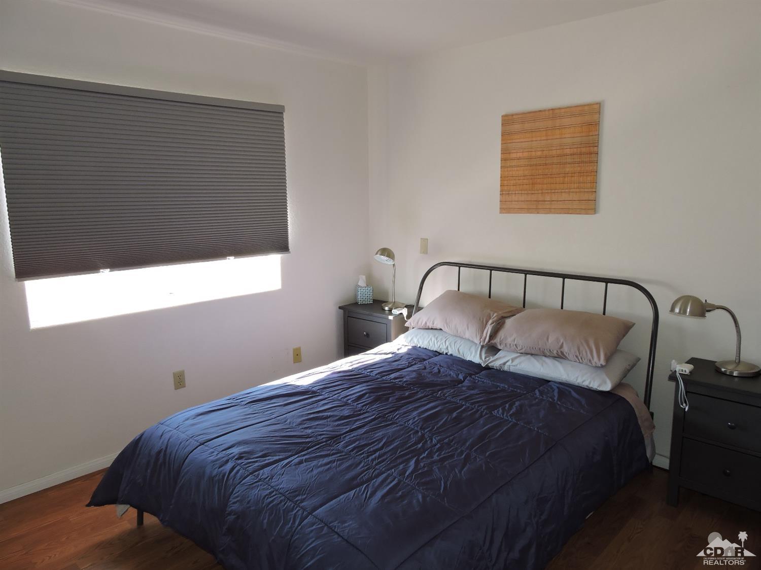 7369 Sunset Road Joshua Tree, CA 92252 - Photo 21 of 37 a bedroom with a bed and window